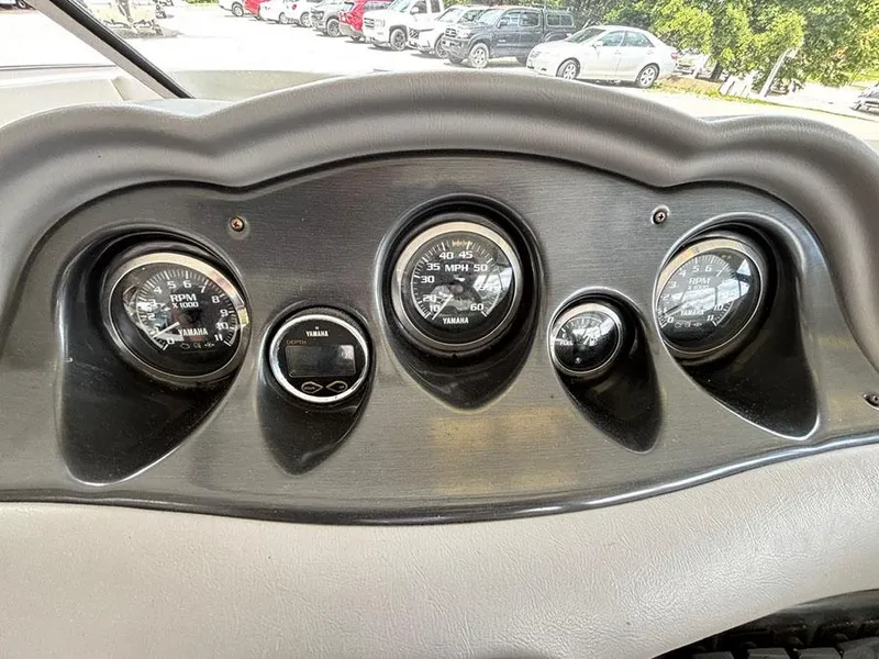 Slide: The Image of Dashboard of 2004 Yamaha Boats 230 SX with gauges and controls. - 13