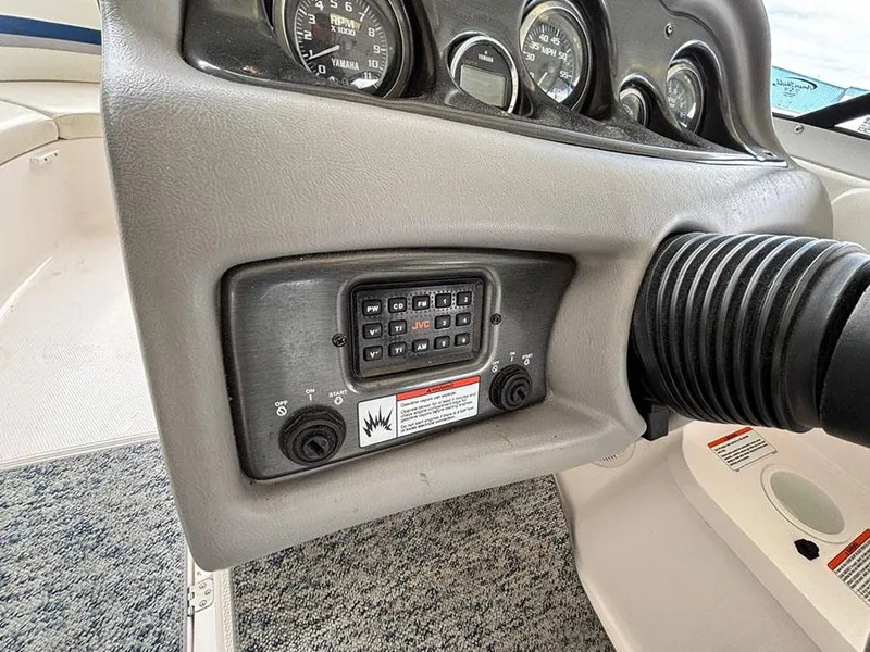 Slide: The Image of 2004 Yamaha Boats 230 SX dashboard with control panel and gauges. - 14