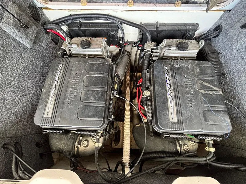 Slide: The Image of 2004 Yamaha Boats 230 SX engine compartment with dual engines and wiring. - 19