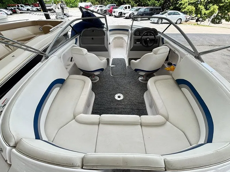 Slide: The Image of 2004 Yamaha Boats 230 SX interior with white seating and steering console. - 4