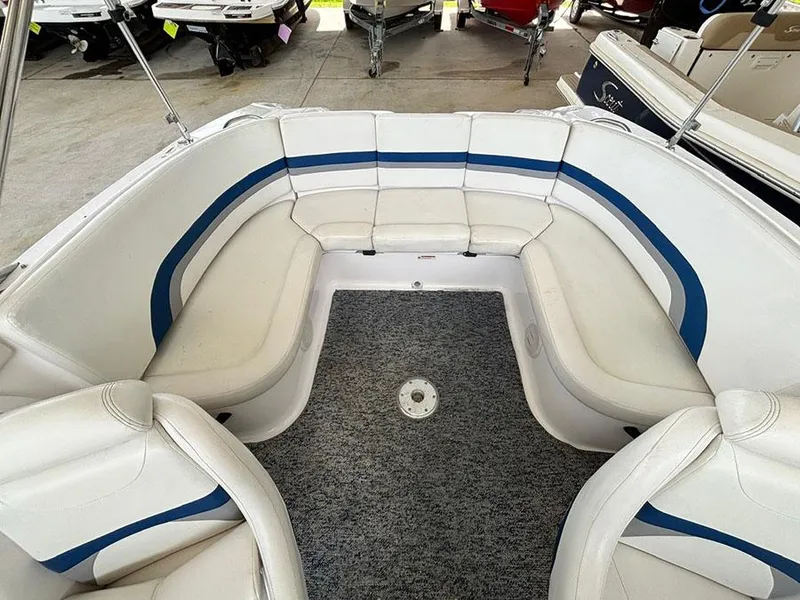 Slide: The Image of 2004 Yamaha Boats 230 SX interior with white and blue seating. - 5