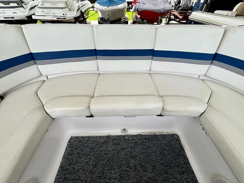 Slide: The Image of 2004 Yamaha Boats 230 SX interior seating with white and blue upholstery. - 7