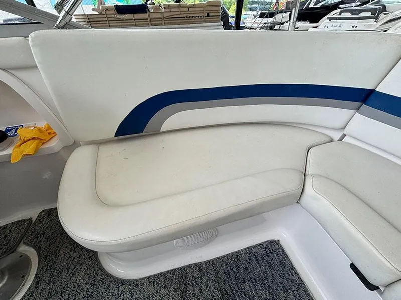 Slide: The Image of 2004 Yamaha Boats 230 SX interior seating with white and blue upholstery. - 8
