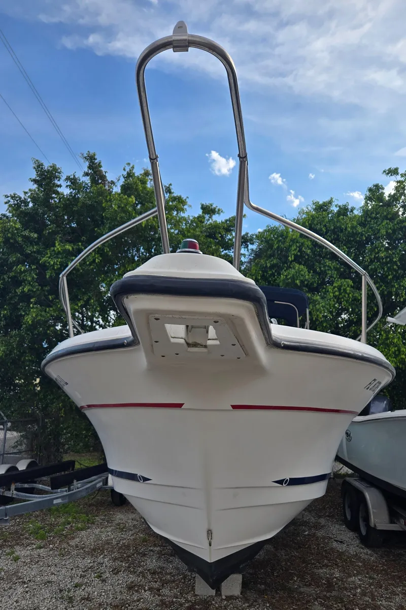 Slide: The Image of 1998 Trophy 2503 Center Console boat, front view, parked on a trailer. - 14
