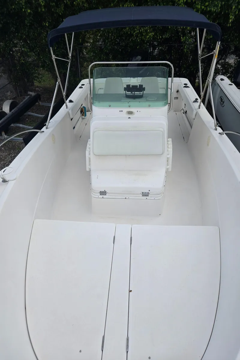 Slide: The Image of 1998 Trophy 2503 Center Console boat with canopy and spacious deck. - 18
