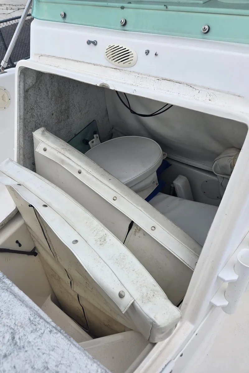 Slide: The Image of 1998 Trophy 2503 Center Console boat interior with storage and seating. - 19