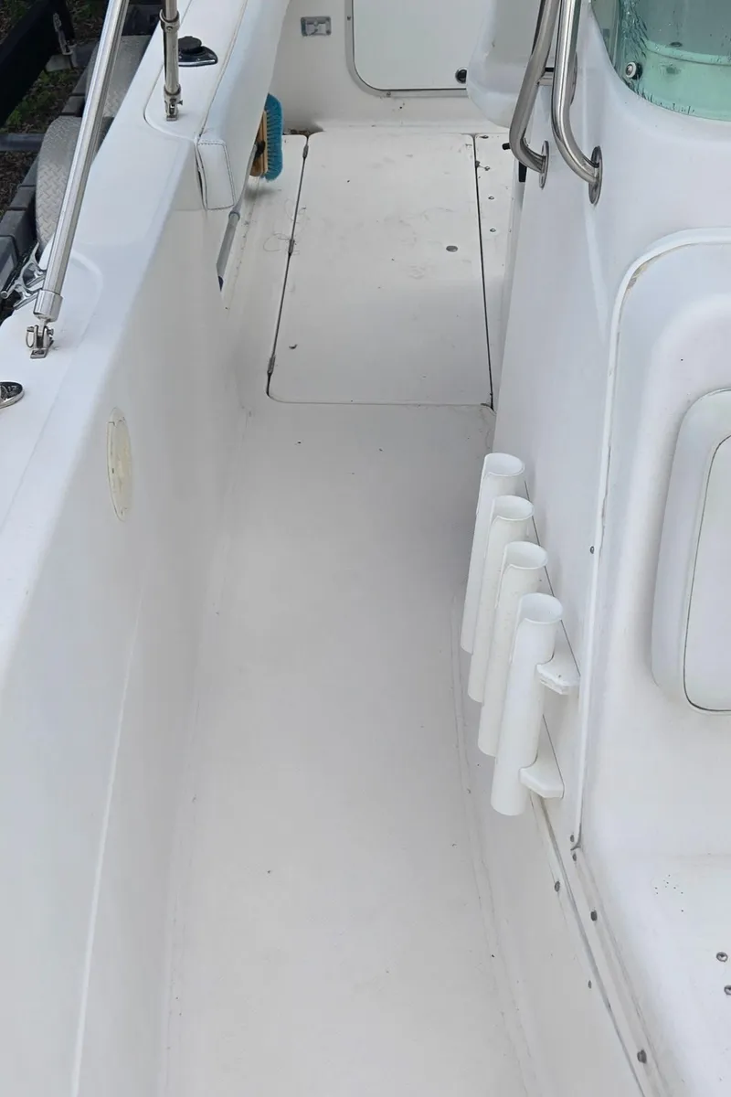 Slide: The Image of 1998 Trophy 2503 Center Console boat interior with rod holders and clean deck. - 21