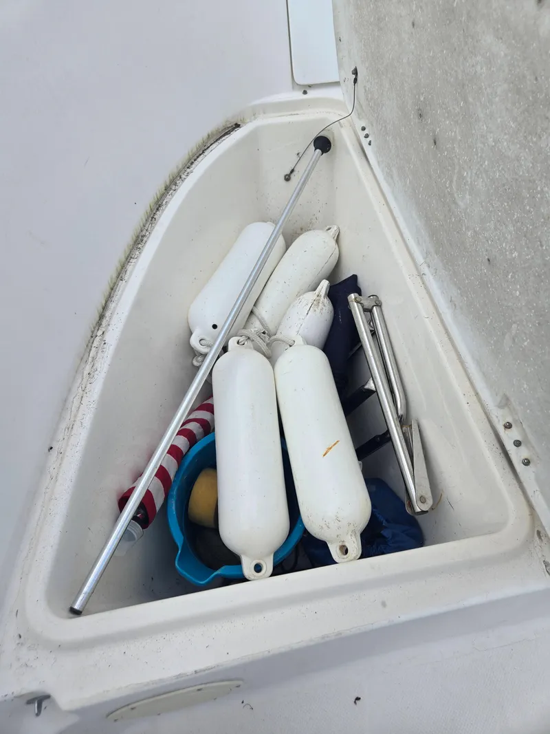 Slide: The Image of Storage compartment on a 1998 Trophy 2503 Center Console boat with fenders and equipment. - 7