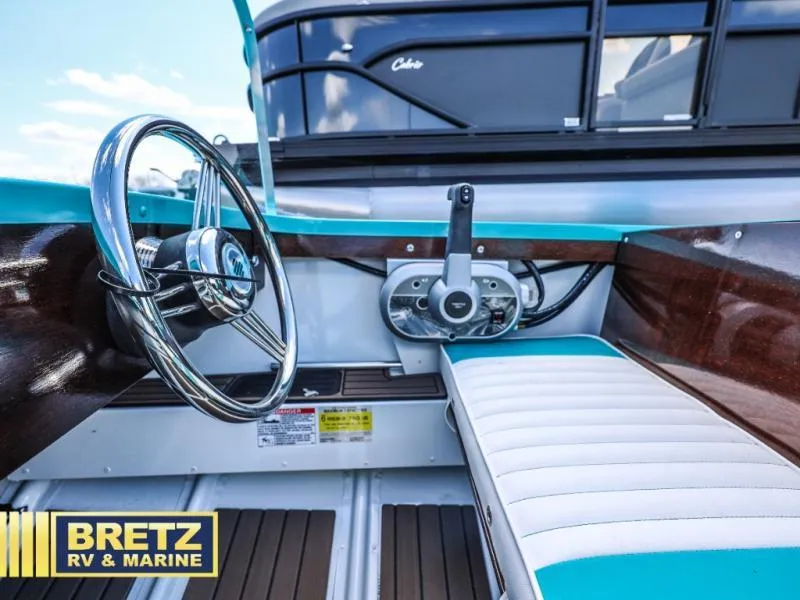 Slide: The Image of 2025 Starcraft 57 SKI CHAMP boat interior with steering wheel and controls. - 11