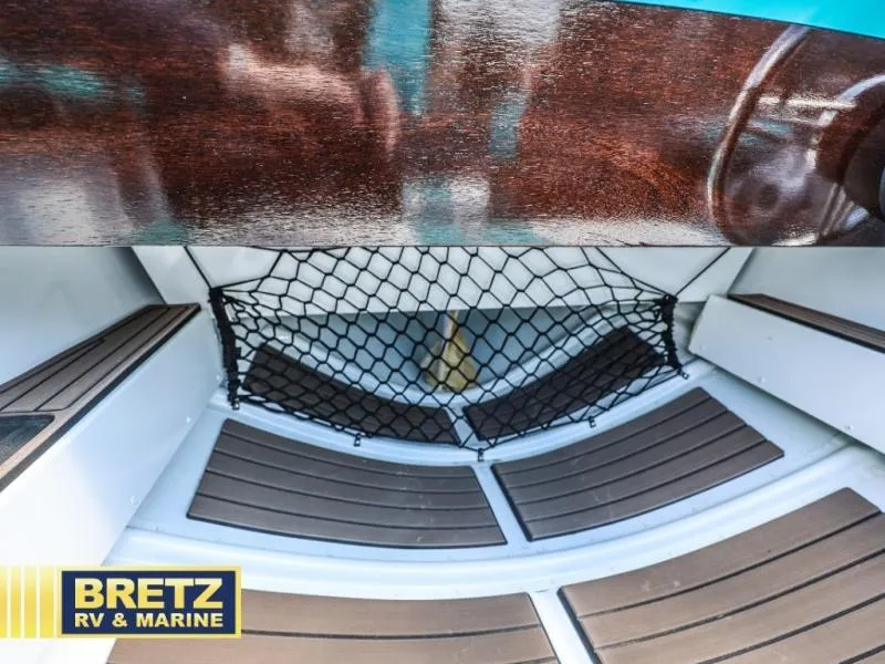 Slide: The Image of Interior of 2025 Starcraft 57 SKI CHAMP boat with wooden flooring and net storage. - 12