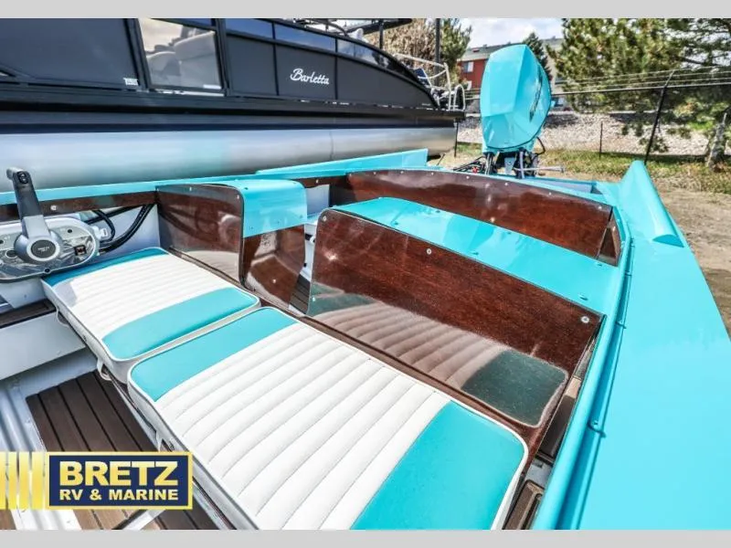 Slide: The Image of 2025 Starcraft 57 SKI CHAMP boat interior with turquoise and white seating, displayed at Bretz RV & Marine. - 13