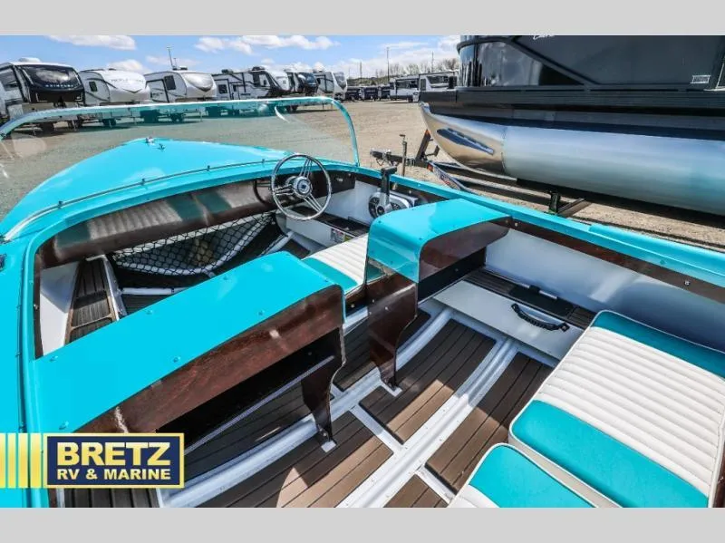 Slide: The Image of 2025 Starcraft 57 SKI CHAMP boat interior with turquoise seats and wooden accents at Bretz RV & Marine. - 9