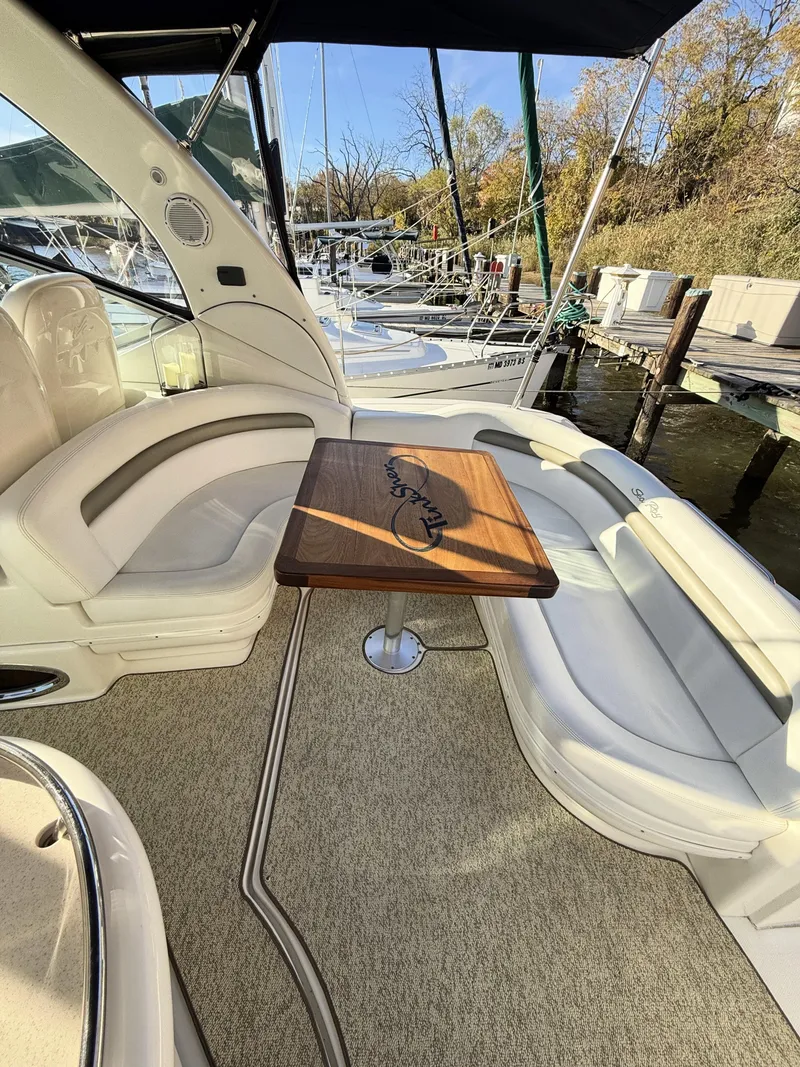 Slide: The Image of 2007 Sea Ray 340 Sundancer interior with elegant seating and wooden table. - 13