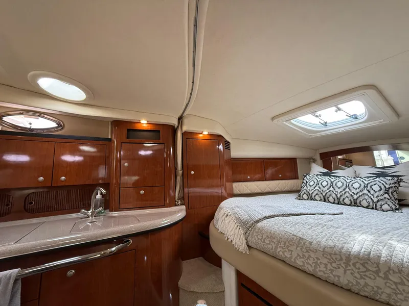 Slide: The Image of Luxurious interior of 2007 Sea Ray 340 Sundancer yacht with elegant wood cabinetry and cozy bedding. - 26