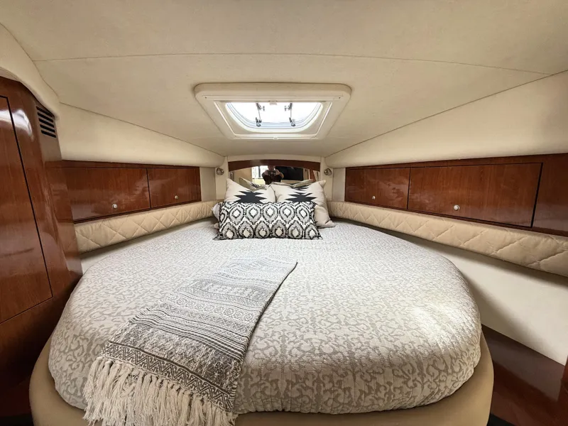 Slide: The Image of Luxurious cabin interior of 2007 Sea Ray 340 Sundancer with elegant bedding and wood accents. - 27