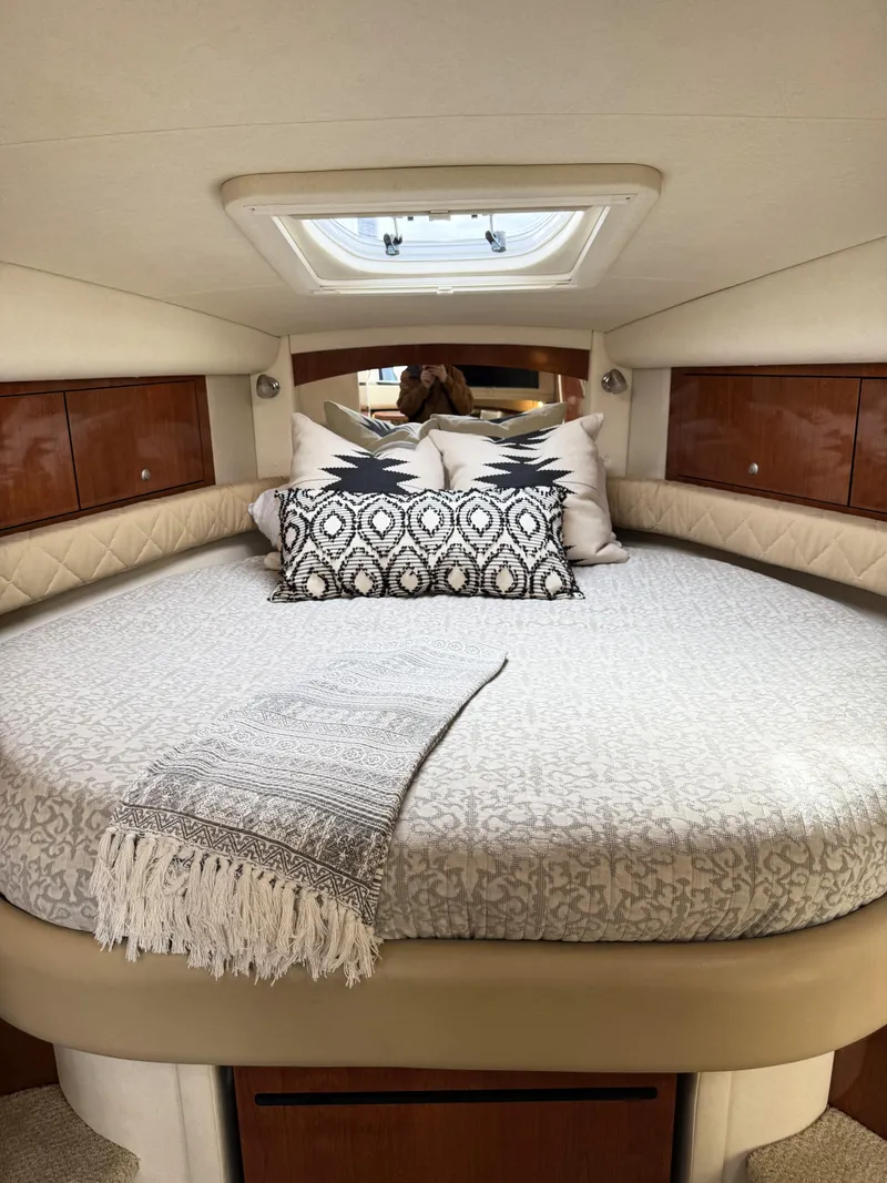 Slide: The Image of Luxurious cabin interior of 2007 Sea Ray 340 Sundancer with elegant bedding and wood accents. - 28