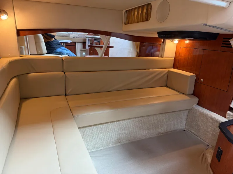 Slide: The Image of Interior of 2007 Sea Ray 340 Sundancer with beige seating and wooden cabinetry. - 31