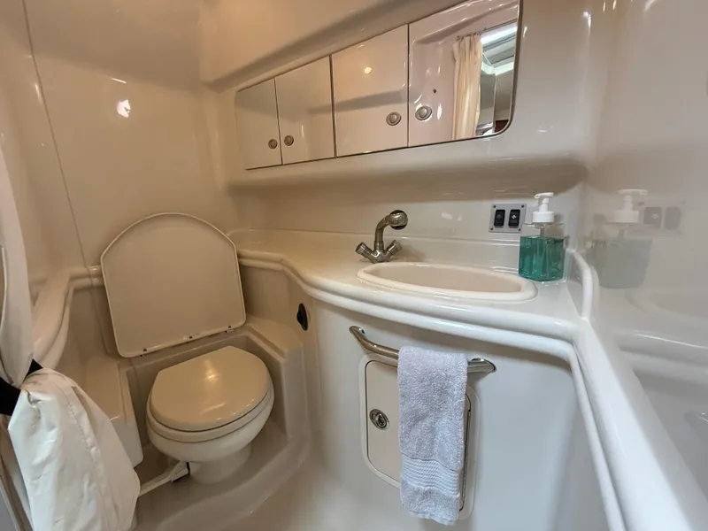 Slide: The Image of 2007 Sea Ray 340 Sundancer bathroom with sink, toilet, and storage cabinets. - 32