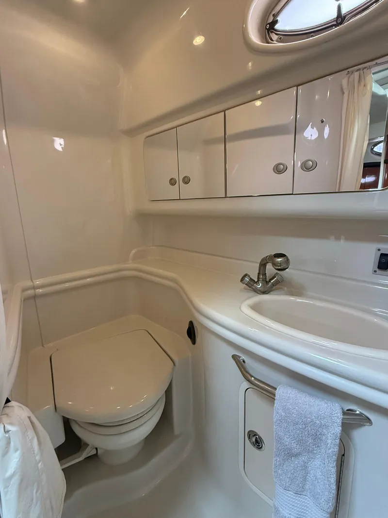Slide: The Image of 2007 Sea Ray 340 Sundancer bathroom with sink, toilet, and storage cabinets. - 33