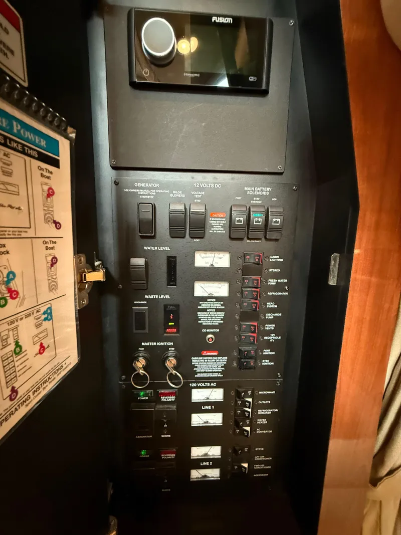 Slide: The Image of Control panel of a 2007 Sea Ray 340 Sundancer boat, featuring various switches and gauges. - 34