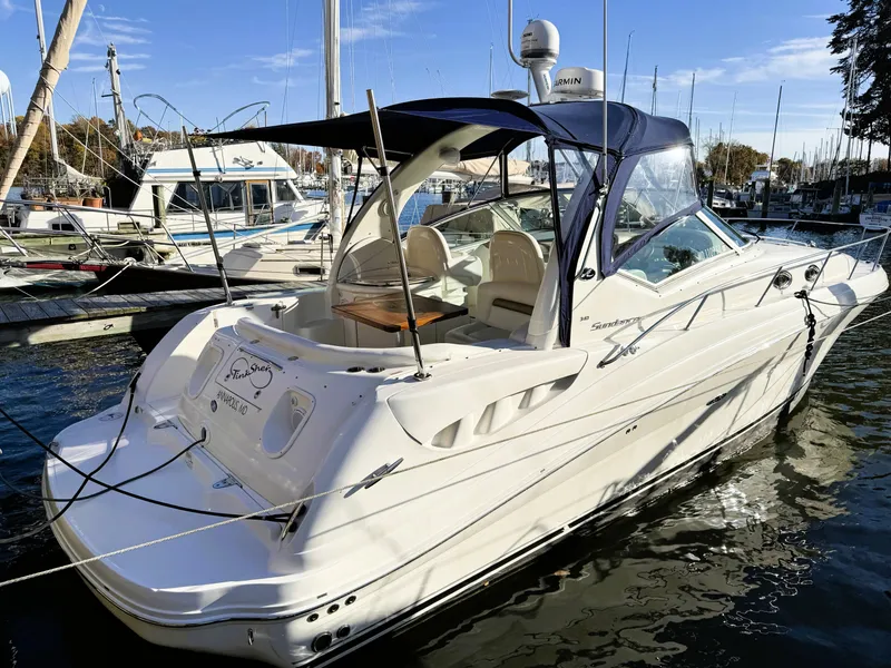 Slide: The Image of 2007 Sea Ray 340 Sundancer docked at marina, featuring sleek design and spacious interior. - 6