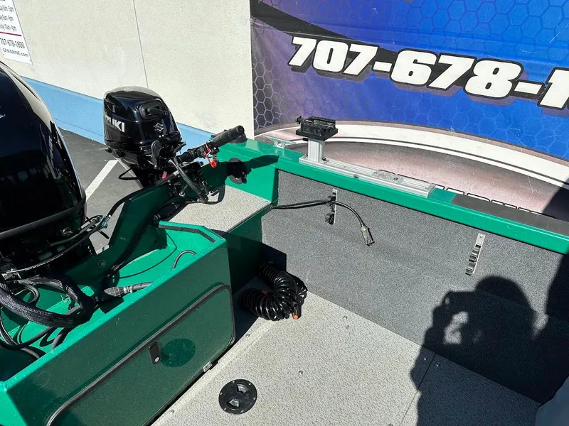 Slide: The Image of 2023 Weldcraft 18 Angler Sport boat interior with motor and control panel. - 15