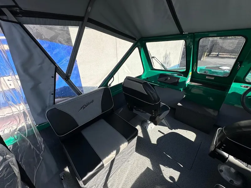 Slide: The Image of 2023 Weldcraft 18 Angler Sport interior with seating and steering console. - 18