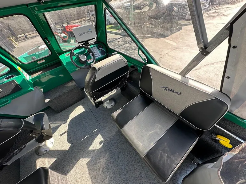 Slide: The Image of Interior of 2023 Weldcraft 18 Angler Sport boat with black seating and steering console. - 20