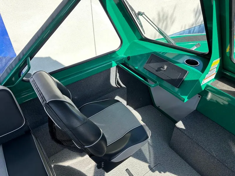 Slide: The Image of 2023 Weldcraft 18 Angler Sport interior with green dashboard and black seat. - 22