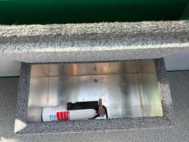 Slide: The Image of Fire extinguisher in storage compartment of 2023 Weldcraft 18 Angler Sport boat. - 30