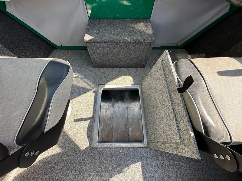 Slide: The Image of 2023 Weldcraft 18 Angler Sport interior with open storage compartment between seats. - 31