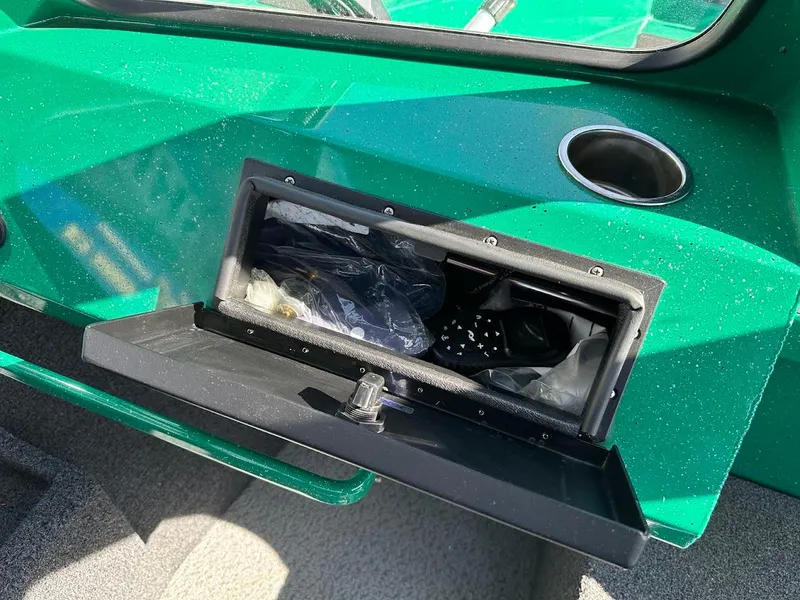 Slide: The Image of 2023 Weldcraft 18 Angler Sport boat storage compartment with open lid, showing interior contents. - 33