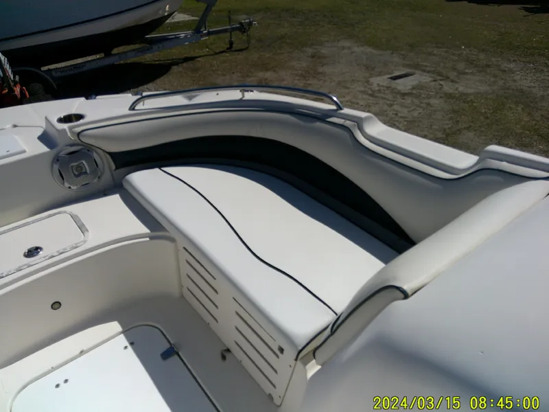 Slide: The Image of 2006 Hurricane Fun Deck 194 boat interior with white seating and speaker. - 11