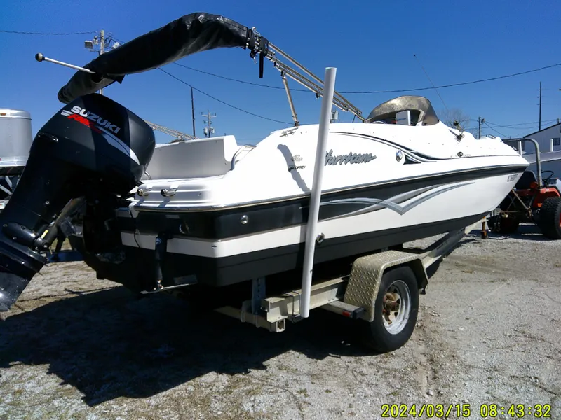 Slide: The Image of 2006 Hurricane Fun Deck 194 boat on trailer with Suzuki outboard motor. - 12