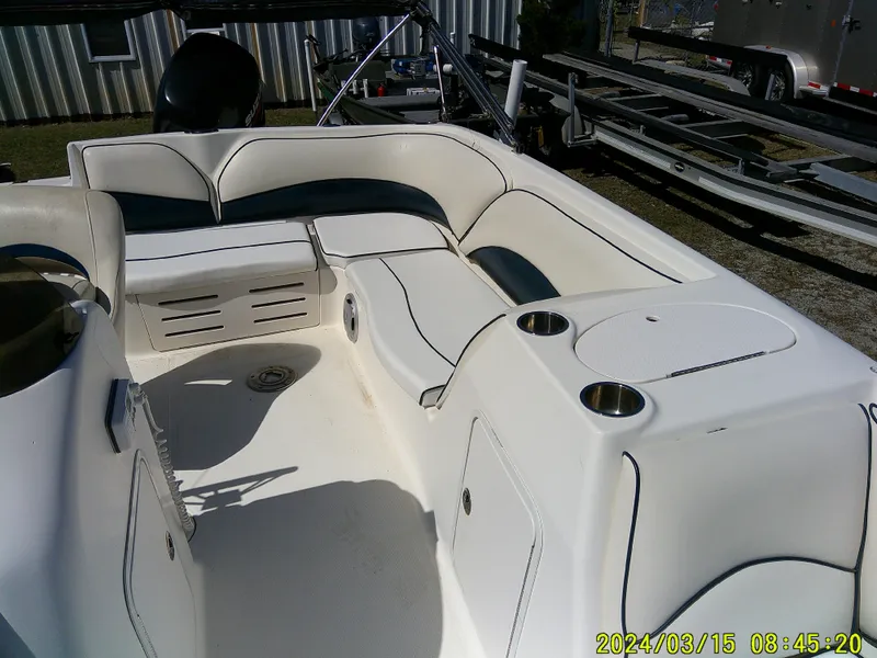 Slide: The Image of 2006 Hurricane Fun Deck 194 interior with white seating and cup holders. - 14