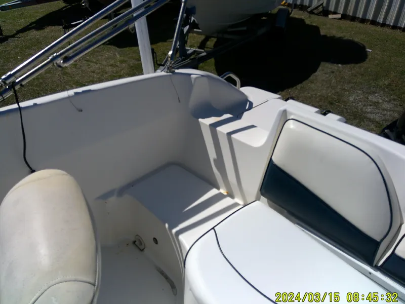 Slide: The Image of 2006 Hurricane Fun Deck 194 boat interior with white seating and storage compartments. - 17