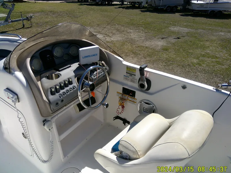 Slide: The Image of 2006 Hurricane Fun Deck 194 boat cockpit with steering wheel and control panel. - 18