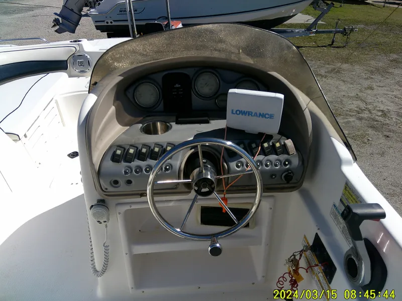 Slide: The Image of 2006 Hurricane Fun Deck 194 boat dashboard with steering wheel and Lowrance navigation system. - 19