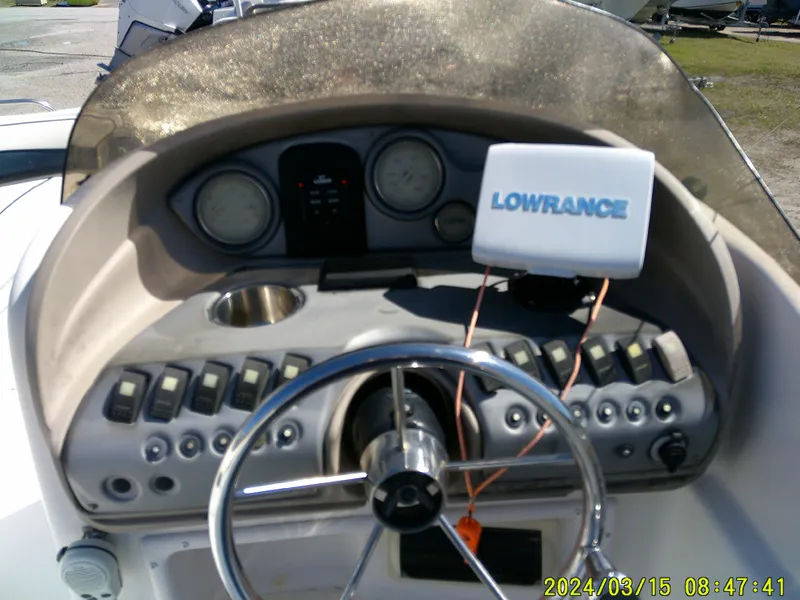 Slide: The Image of 2006 Hurricane Fun Deck 194 dashboard with steering wheel and Lowrance navigation system. - 21