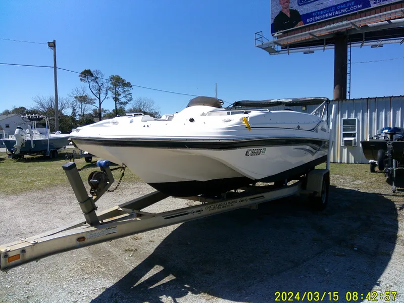 Slide: The Image of 2006 Hurricane Fun Deck 194 boat on trailer in outdoor setting. - 3