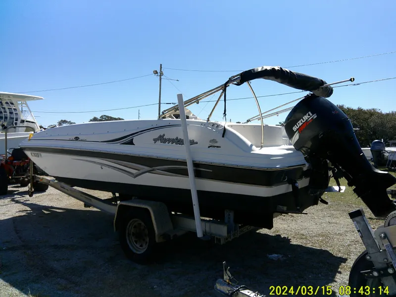 Slide: The Image of 2006 Hurricane Fun Deck 194 boat on trailer with Suzuki outboard motor. - 8