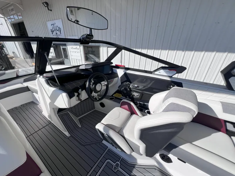 Slide: The Image of 2021 Nautique Super Air G23 boat interior with modern dashboard and seating. - 11