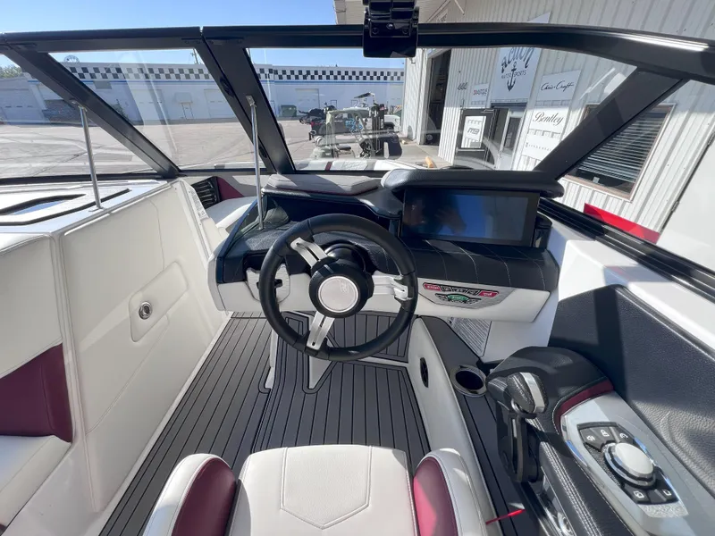 Slide: The Image of 2021 Nautique Super Air G23 boat interior with modern dashboard and steering wheel. - 12