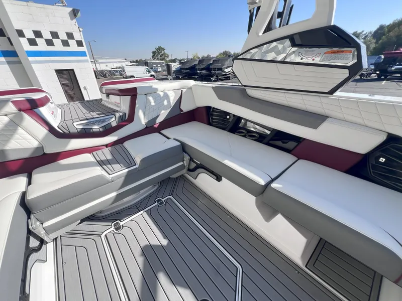 Slide: The Image of 2021 Nautique Super Air G23 boat interior with white and gray seating. - 16
