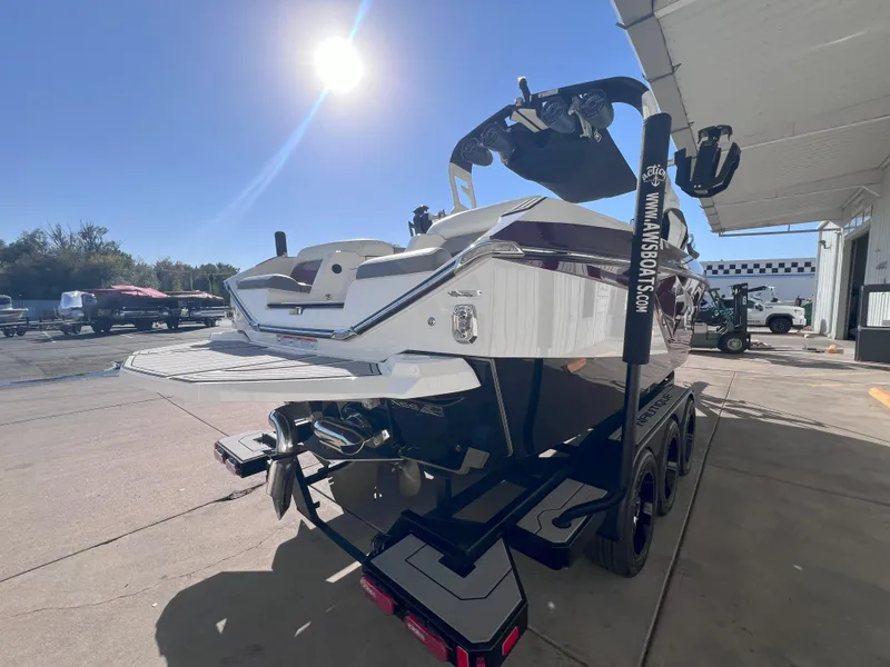 Slide: The Image of 2021 Nautique Super Air G23 boat on trailer under sunny sky. - 6