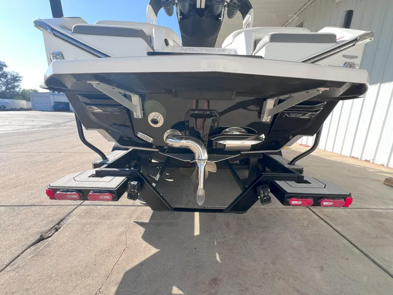 Slide: The Image of 2021 Nautique Super Air G23 boat rear view, showcasing sleek design and features. - 7