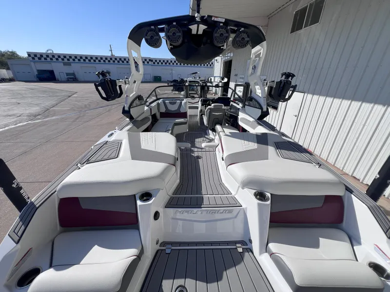 Slide: The Image of 2021 Nautique Super Air G23 boat interior with sleek seating and advanced controls. - 9