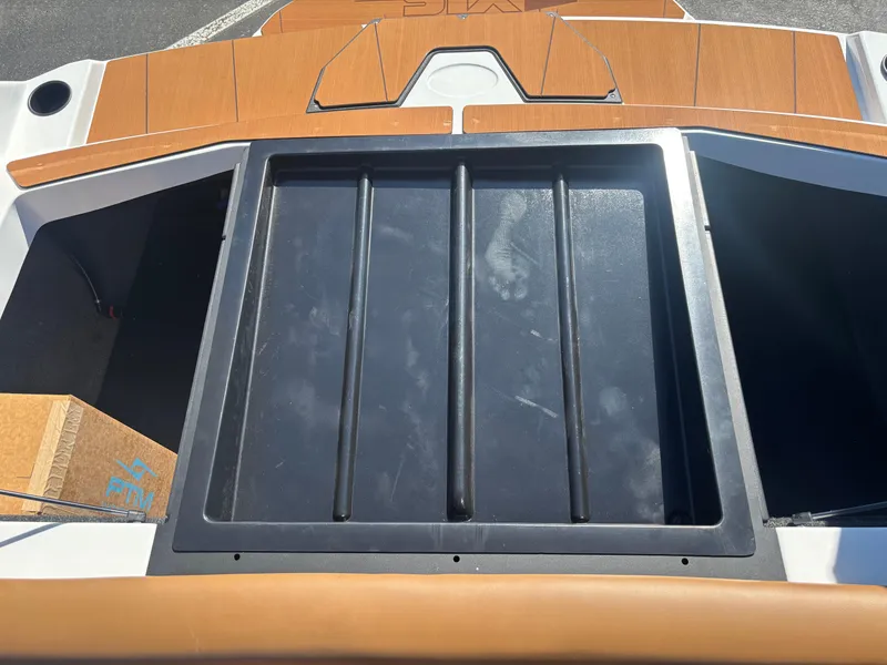 Slide: The Image of 2025 Axis A225 boat storage compartment with wooden accents. - 12