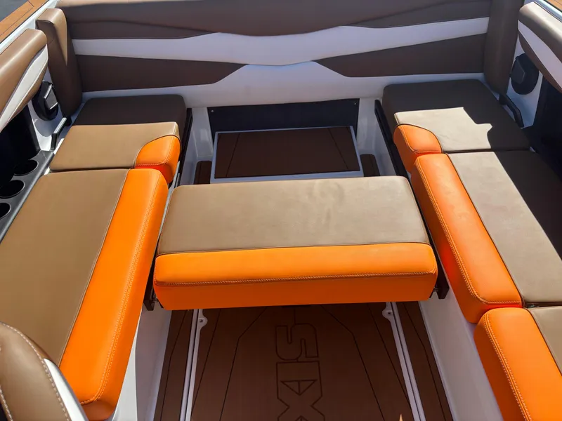 Slide: The Image of 2025 Axis A225 boat interior with orange and brown seating arrangement. - 14