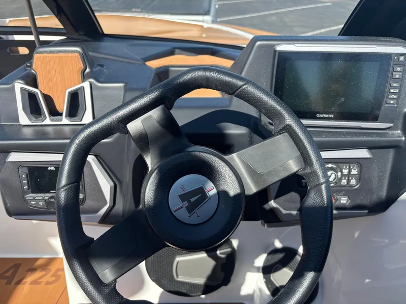 Slide: The Image of Steering wheel and dashboard of 2025 Axis A225 boat with Garmin display. - 5